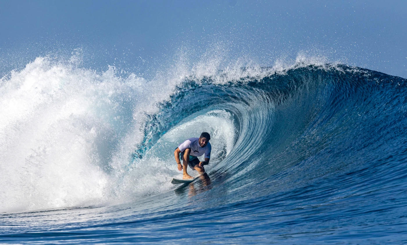 Steven surfing deep inside the barrel of a breaking wave